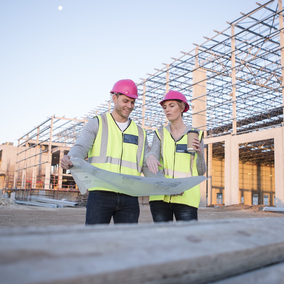 Construction workers looking at blueprint